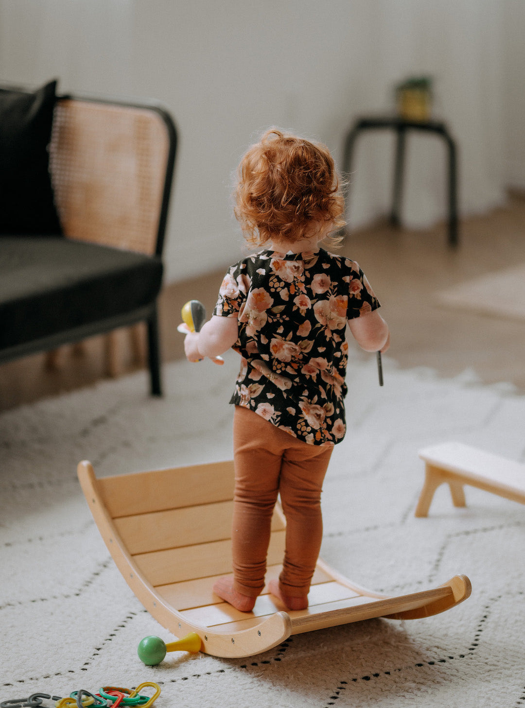 toddler playing on a wobble balance board